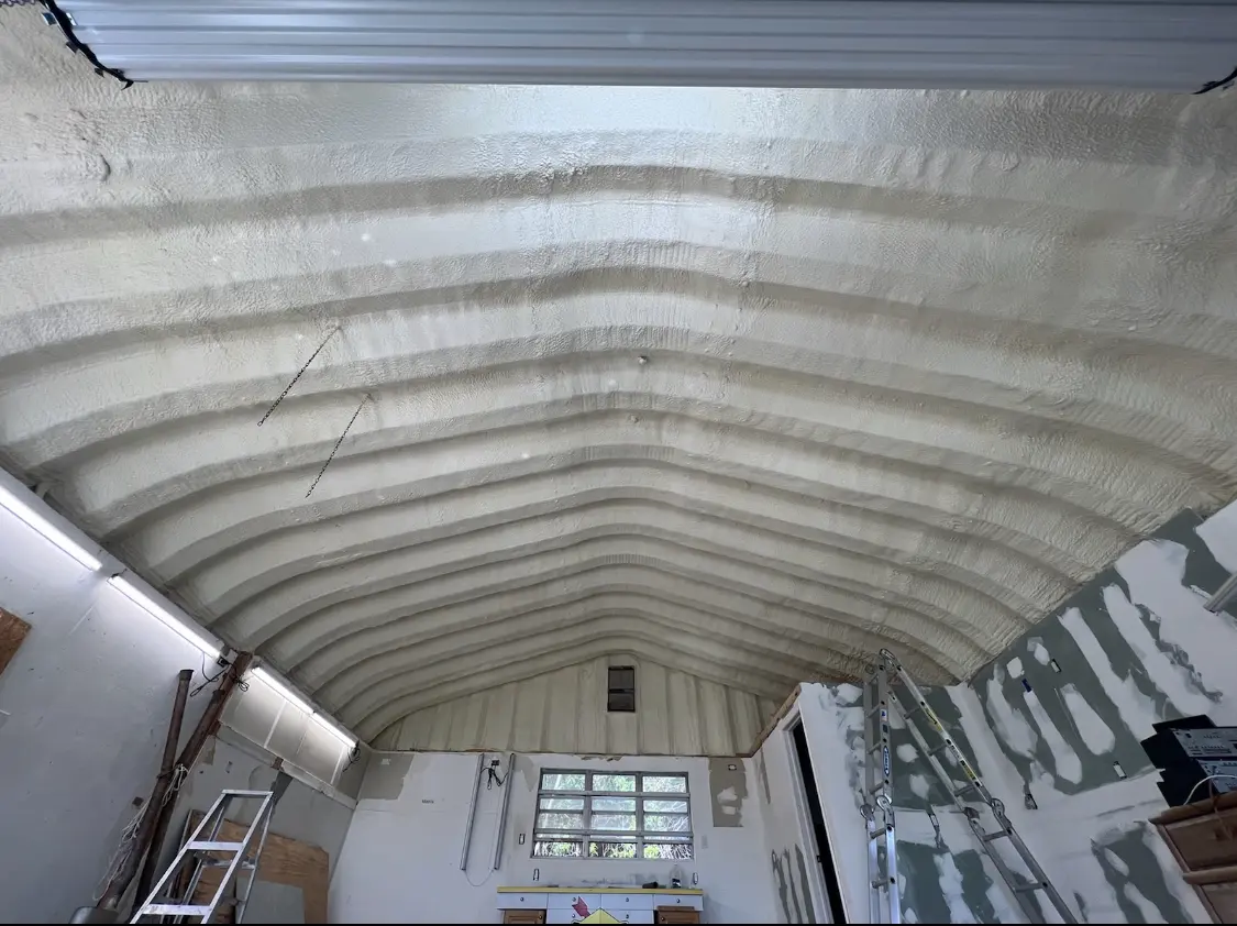 Spray polyurethane foam applied to the underside of a metal roof deck in New Carrollton